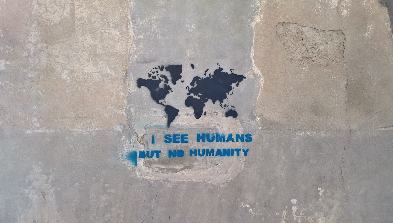 White and Blue Quote on Gray Concrete Wall